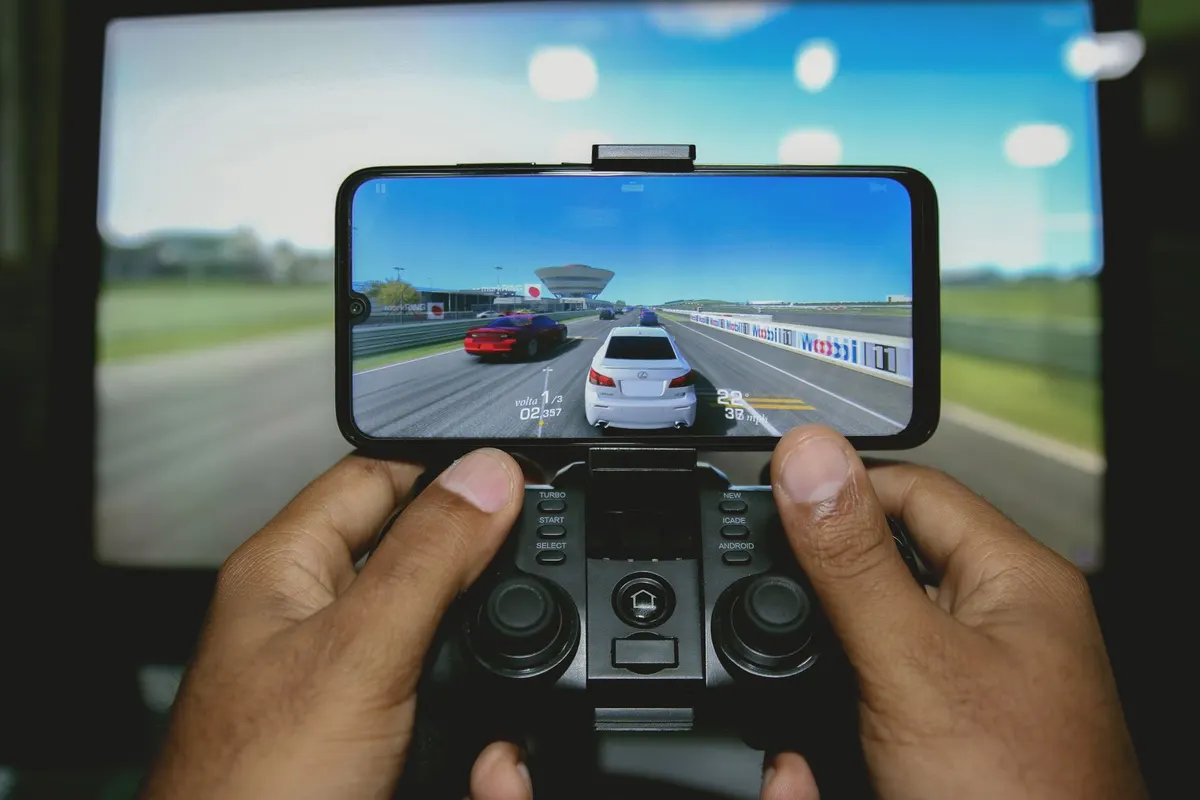 Hands holding a phone playing a game