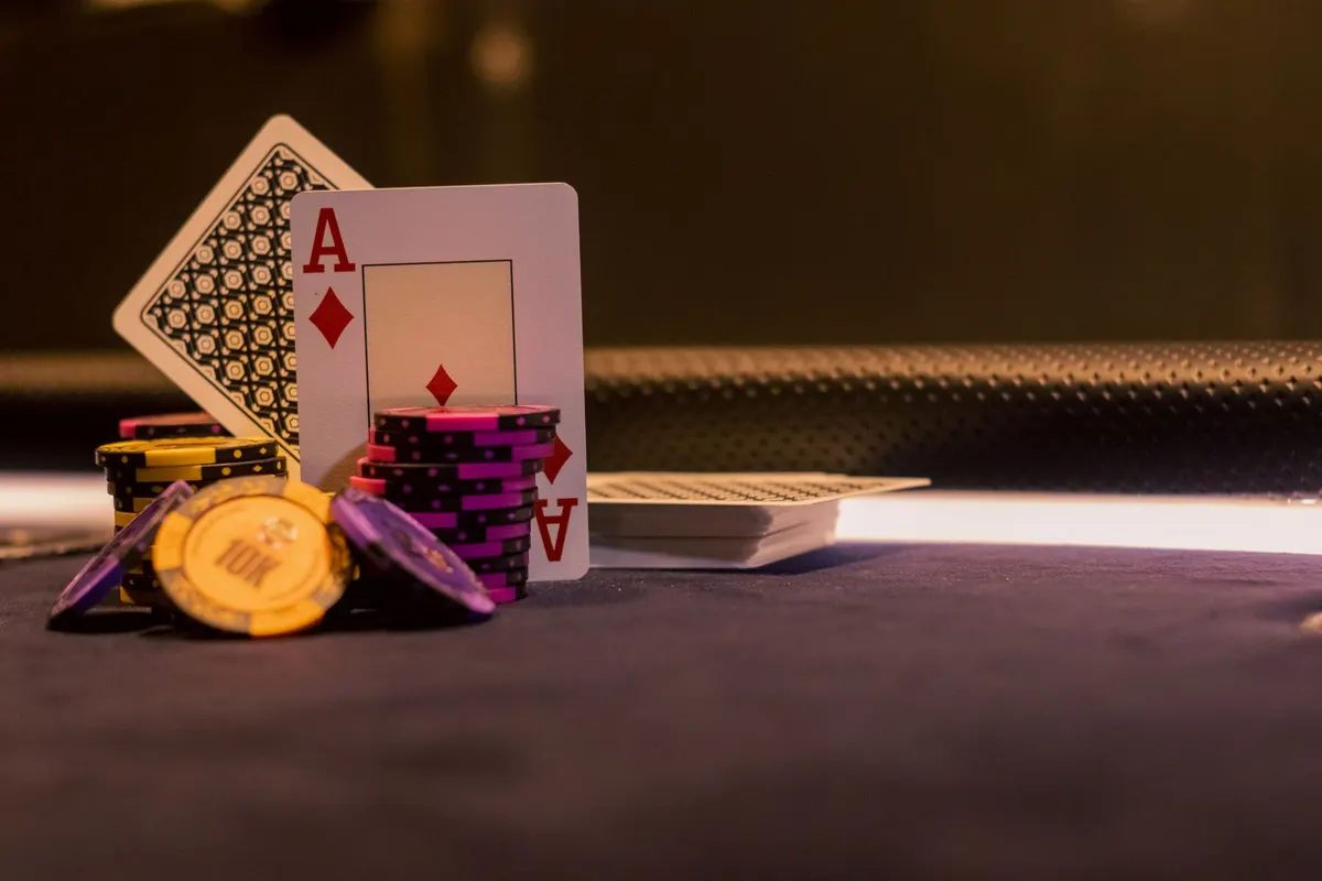 Casino chips and cards on a table representing real money play