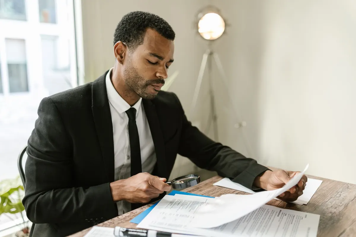 Magnifying glass over a document representing verification